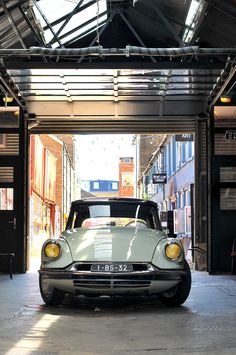 an old car is parked in a garage