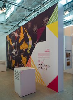 an exhibit in a building with colorful designs on the wall