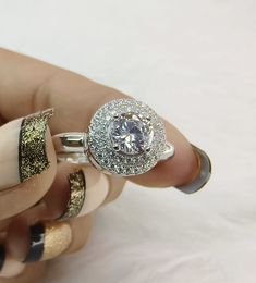 a woman's hand holding a diamond ring with gold and silver glitters on it