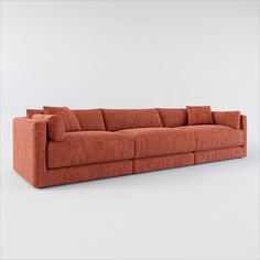 an orange couch sitting on top of a white floor