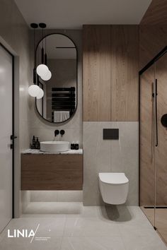 a bathroom with a toilet, sink and mirror in it's center wall next to a walk in shower