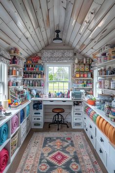 a room filled with lots of crafting supplies on top of wooden shelves next to a window