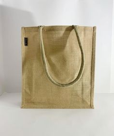 a beige bag sitting on top of a white table