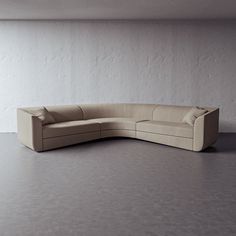 a corner couch sitting in front of a white wall