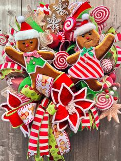 a christmas wreath with gingerbreads, candy canes and santa hats on it