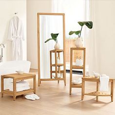 a white bathroom with wooden furniture and mirrors