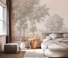 a bedroom with a large wallpapered tree mural behind the bed and side table