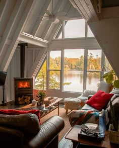 a living room filled with furniture and a fire place in the middle of a room