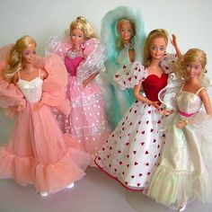 six barbie dolls are posed together in dresses