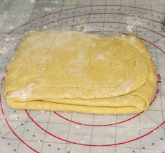 two uncooked pizza doughs on a wire rack