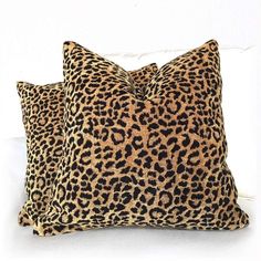 two leopard print pillows on a white couch