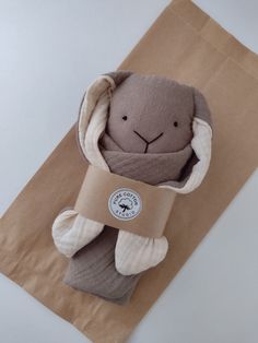 a stuffed animal wrapped in a brown paper bag