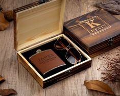 a personalized flask and sunglasses in a wooden box