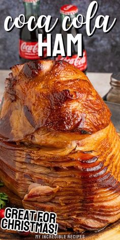 a large roasting ham on a cutting board with coca cola bottles in the background