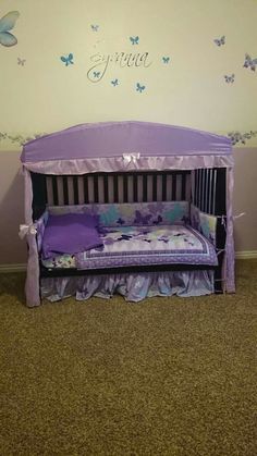 a purple bed with butterflies on the wall