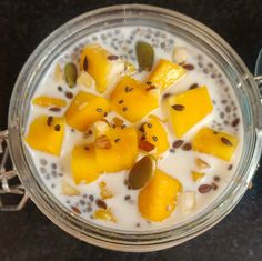 a glass bowl filled with fruit and yogurt