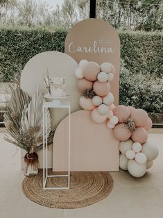 a pink and white baby shower with balloons