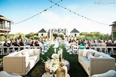 an outdoor ceremony with couches and chairs