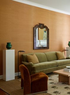 a living room filled with furniture and a mirror