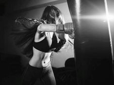 black and white photograph of a woman boxing