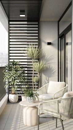 a balcony with two chairs and a table on the floor next to potted plants