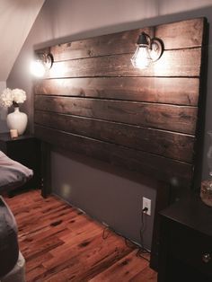 there is a bed with two lights on the headboard