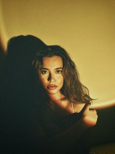 a woman with long hair posing for the camera