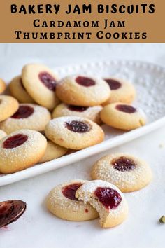 small cookies with jam on them in a white plate