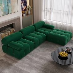 a large green couch sitting in front of a fire place next to a table with some food on it