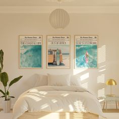 a bedroom with two posters above the bed