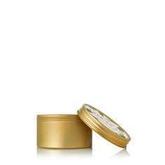 a gold tin with a white label on the top and bottom, sitting in front of a white background