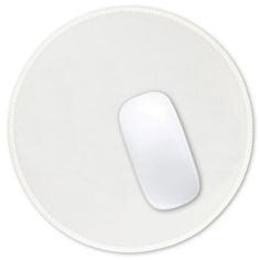 a white computer mouse pad on a white surface with an oval button in the middle