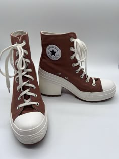 Elevate your casual style with these limited edition Converse Chuck 70 De Lux Heel Hi Pride sneakers. The tawny owl color with glitter accents adds a touch of uniqueness to any outfit. These high top sneakers have a lace-up closure for a secure fit and a rubber outsole for durability. The synthetic upper material is breathable and comfortable, while the foam insole provides added support. Perfect for walking, these athletic sneakers are suitable for all seasons. With a style code of A05253C and a US shoe size of 10 (women's 8), these Converse Chuck 70 sneakers are a must-have for any sneaker enthusiast. Converse High Heels, Pride Sneakers, Real Outfits, Heel Sneakers, Therian Stuff, Tawny Owl, Dream Aesthetic, Sneakers Womens, Converse Chuck 70