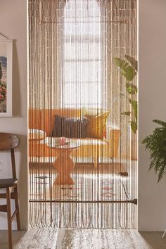 a living room with an open door and curtains