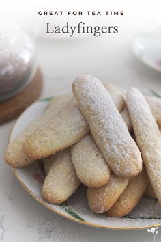 a white plate topped with cookies covered in powdered sugar on top of a table