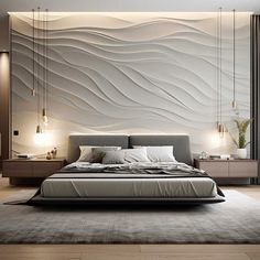 a large bed sitting in the middle of a bedroom next to a wall with waves on it