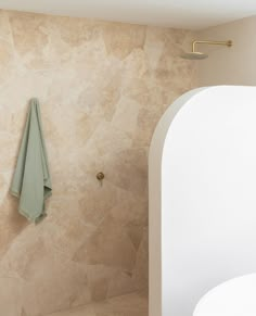 a white toilet sitting next to a shower in a bathroom