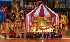 there are many toys on the floor in this playroom, including a circus tent