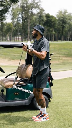 a man standing next to a golf cart