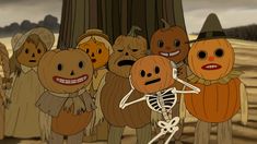 a group of cartoon pumpkins standing next to each other in front of a tree