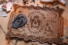 a wooden plaque with a skull on it next to some other items and tools,