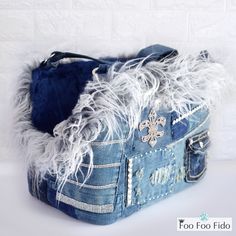 a denim purse with white fur on it