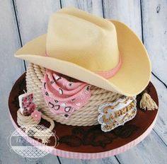 a cowboy hat on top of a brown and white plate with other items around it