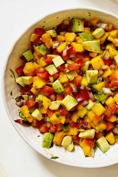 a white bowl filled with chopped vegetables on top of a table