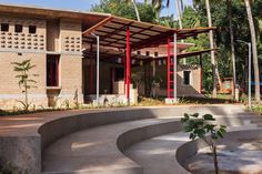 an outdoor area with concrete steps and red railings, surrounded by tall palm trees