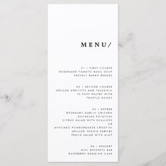 a white menu card sitting on top of a marble table