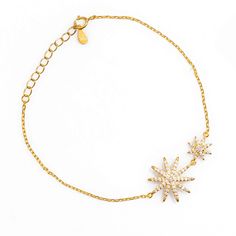 Illuminate your style with Stellar Star Gold & Diamond Chain Bracelet, a beautifully crafted piece that combines elegance with celestial charm. Made from 18K gold-plated sterling silver, this bracelet features two star motifs—one large and one small—each adorned with sparkling Cz diamonds that shimmer like starlight. The stars, set on a delicate and refined chain, radiate a spiritual aura that perfectly complements your wrist. Designed to be worn every day or for special occasions, this bracelet will be your go-to accessory, adding a touch of brilliance to any outfit. Its sleek and graceful design ensures you’ll never want to take it off, as it shines with you in every setting. Details 18K gold plated on Sterling silver Cz diamonds Adjustable size 6. 5'' to 8'' Avoid contact with chemicals Yellow Gold Star Charm Bracelet, Elegant Sterling Silver Star Bracelet, Elegant Sterling Silver Bracelets With Star Charm, Elegant Yellow Gold Star Bracelet, Elegant Yellow Gold Jewelry With Star Charm, Celestial Style Yellow Gold Bracelet, Elegant Star-shaped Chain Bracelet As Gift, Luxury Gold Star Bracelets, Elegant Star-shaped Chain Bracelet Gift