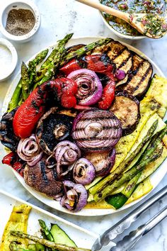 a plate with grilled meat and vegetables on it