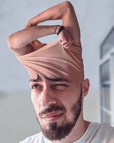 a man with his hair tied back and wearing a ring on top of his head