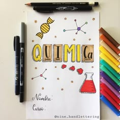 a notebook with the word quimica written on it next to crayons and markers